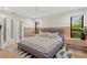 Modern main bedroom featuring accent wall, stylish rug, and glass doors to en suite at 2665 Clubhouse N Dr, Clearwater, FL 33761