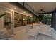 Relaxing covered patio with comfortable seating, a ceiling fan, and views of the landscaped backyard at 2665 Clubhouse N Dr, Clearwater, FL 33761