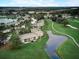 Aerial view of community with pond, manicured lawns, and convenient parking at 29129 Bay Hollow Dr # 3201, Wesley Chapel, FL 33543