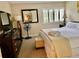 Well-lit bedroom with stylish dresser, soft accent chair, and comfortable king bed at 29129 Bay Hollow Dr # 3201, Wesley Chapel, FL 33543
