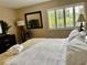 Serene bedroom featuring a well-lit window, dresser, and a comfortable bed with premium bedding at 29129 Bay Hollow Dr # 3201, Wesley Chapel, FL 33543