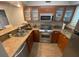 Modern kitchen with stainless steel appliances, granite countertops, and wooden cabinetry is equipped for modern cooking at 29129 Bay Hollow Dr # 3201, Wesley Chapel, FL 33543