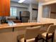 Modern kitchen with stainless steel appliances, granite countertops, and bar stool seating at 29129 Bay Hollow Dr # 3201, Wesley Chapel, FL 33543