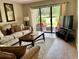 Comfortable living area featuring view of the outdoor patio with red furniture at 29129 Bay Hollow Dr # 3201, Wesley Chapel, FL 33543