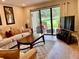 Bright living room with cozy furnishings and view of the outdoor patio at 29129 Bay Hollow Dr # 3201, Wesley Chapel, FL 33543