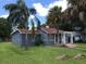 Charming single-story home with a red roof, mature landscaping, and inviting front porch at 3007 Clinton S St, Gulfport, FL 33707