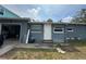 Rear of the property showing access to a garage and fenced backyard at 3007 Clinton S St, Gulfport, FL 33707