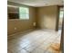 Neutral bedroom with tile floors, natural light, and minimal design elements at 310 2Nd Nw Ave, Ruskin, FL 33570