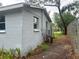 Exterior view of the home showcasing the siding, a window, and an air conditioning unit at 310 2Nd Nw Ave, Ruskin, FL 33570