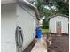 View of the side yard featuring an exterior building, utility box, and partial view of an adjacent yard at 310 2Nd Nw Ave, Ruskin, FL 33570