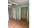 Bedroom featuring laminate floors, closet, and bright neutral paint at 3145 Meta Ct, Largo, FL 33771