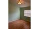 Cozy bedroom with hardwood floors, ceiling fan and a window at 3145 Meta Ct, Largo, FL 33771