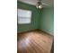 Bright bedroom features hardwood floors, a ceiling fan, and a window with natural light at 3145 Meta Ct, Largo, FL 33771