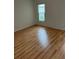 Bedroom showcasing the laminate floor and window for natural light at 3145 Meta Ct, Largo, FL 33771