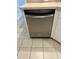 Stainless steel dishwasher integrated into the kitchen cabinetry with tile flooring at 3145 Meta Ct, Largo, FL 33771