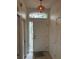 A front door with a window above, tiled entry and a decorative light fixture at 3145 Meta Ct, Largo, FL 33771