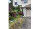 Two-story home exterior with a well manicured front yard and attached garage at 3145 Meta Ct, Largo, FL 33771