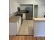 Kitchen with tile floors, stainless steel refrigerator, white cabinetry, and laminate counters at 3145 Meta Ct, Largo, FL 33771