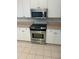 Modern kitchen featuring stainless steel oven and microwave, complemented by white cabinetry at 3145 Meta Ct, Largo, FL 33771