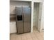 Stainless steel refrigerator with water dispenser, next to a pantry with wire shelves at 3145 Meta Ct, Largo, FL 33771