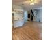Living room featuring hardwood floors, a kitchen view, and stairs to the second floor at 3145 Meta Ct, Largo, FL 33771