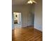 Spacious main bedroom featuring hardwood floors, ensuite bathroom, and closet at 3145 Meta Ct, Largo, FL 33771