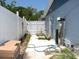 Sideyard area featuring privacy fence and a water filtration system at 3424 Truman Dr, Holiday, FL 34691