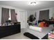 Bedroom with neutral tile flooring, a decorative dresser, and light gray walls at 3424 Truman Dr, Holiday, FL 34691