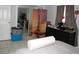 Tidy bedroom featuring tiled flooring, closet with mirror doors, and simple decor at 3424 Truman Dr, Holiday, FL 34691
