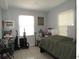 Bedroom featuring natural light, tile flooring, and a modern accent wall at 3424 Truman Dr, Holiday, FL 34691