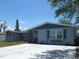 Charming single-story home featuring a spacious driveway and a quaint front porch at 3424 Truman Dr, Holiday, FL 34691