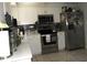 Well-equipped kitchen with stainless steel appliances, white cabinetry, and modern finishes at 3424 Truman Dr, Holiday, FL 34691