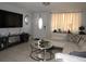 Comfortable living room featuring a large TV, modern decor, and inviting ambiance at 3424 Truman Dr, Holiday, FL 34691