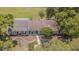 Aerial view of a home with a well-maintained lawn and mature landscaping at 35058 Whispering Oaks Blvd, Dade City, FL 33523