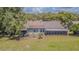 Spacious backyard featuring lush greenery and multiple seating areas perfect for outdoor enjoyment at 35058 Whispering Oaks Blvd, Dade City, FL 33523
