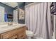 Bathroom with a vanity, faucet, mirror, and shower with curtain at 35058 Whispering Oaks Blvd, Dade City, FL 33523