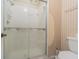 Bathroom featuring a glass shower door and toilet at 35058 Whispering Oaks Blvd, Dade City, FL 33523