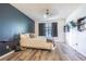 Bedroom featuring a bed, dark blue accent wall, and laminate flooring at 35058 Whispering Oaks Blvd, Dade City, FL 33523