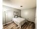 Bedroom showcasing neutral tones, wood-look flooring, and a comfortable twin bed at 35058 Whispering Oaks Blvd, Dade City, FL 33523
