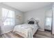 Comfortable bedroom featuring hardwood flooring and natural lighting at 35058 Whispering Oaks Blvd, Dade City, FL 33523