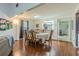 Dining room with wood floors, adjacent to the kitchen and front entry at 35058 Whispering Oaks Blvd, Dade City, FL 33523