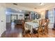 Spacious dining room with hardwood floors open to the living room with fireplace at 35058 Whispering Oaks Blvd, Dade City, FL 33523