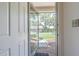 Entryway featuring a view of the front yard through the open front door and storm door at 35058 Whispering Oaks Blvd, Dade City, FL 33523