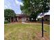 Charming brick home with a well-maintained lawn and mature trees, offering a cozy curb appeal at 35058 Whispering Oaks Blvd, Dade City, FL 33523