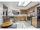 Bright kitchen featuring wood cabinetry, modern appliances, and a skylight illuminating the space at 35058 Whispering Oaks Blvd, Dade City, FL 33523