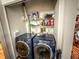 Laundry area with washer, dryer, and shelving for storage and organization at 35058 Whispering Oaks Blvd, Dade City, FL 33523