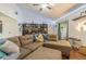 Comfortable living room with a sectional sofa, bookshelves, and wood floors at 35058 Whispering Oaks Blvd, Dade City, FL 33523
