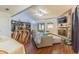 Living room, from dining room featuring fireplace and comfortable couch with wood floors at 35058 Whispering Oaks Blvd, Dade City, FL 33523