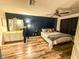 Serene main bedroom with hardwood floors, a ceiling fan, and a convenient en-suite bathroom, designed for comfort at 35058 Whispering Oaks Blvd, Dade City, FL 33523