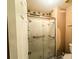 Shower featuring tile surround, glass doors and handrails at 35058 Whispering Oaks Blvd, Dade City, FL 33523